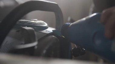 Petrol bir atölyede mavi bir chainsaw ekleme. 