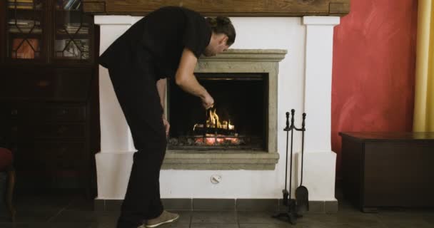 Man Poking Fire Burning Fireplace — Stock Video