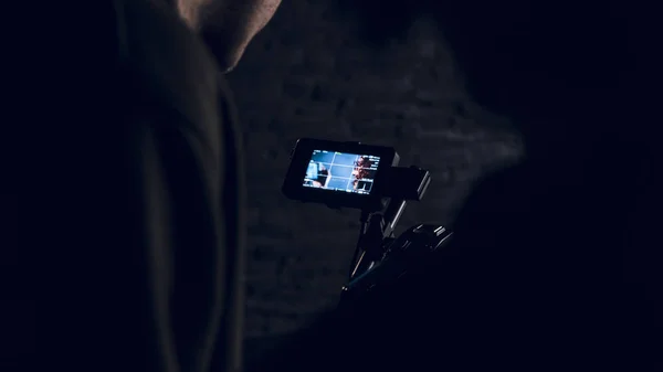 Man is looking on the display of the camera — Stock Photo, Image