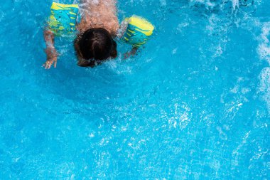 Yaz aylarında bir havuz serin su sıçramasına çocuk