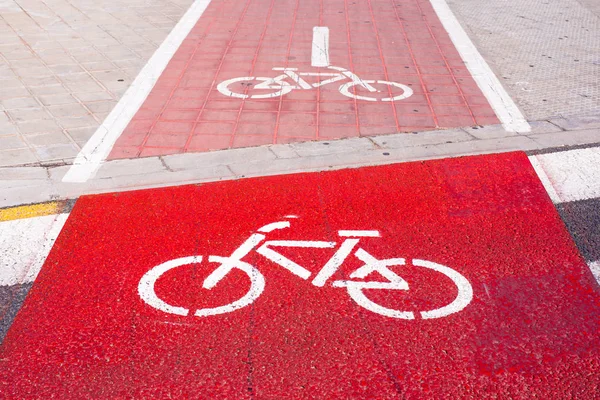 Signs and bike lane markings painted on the asphalt of the streets of an urban city