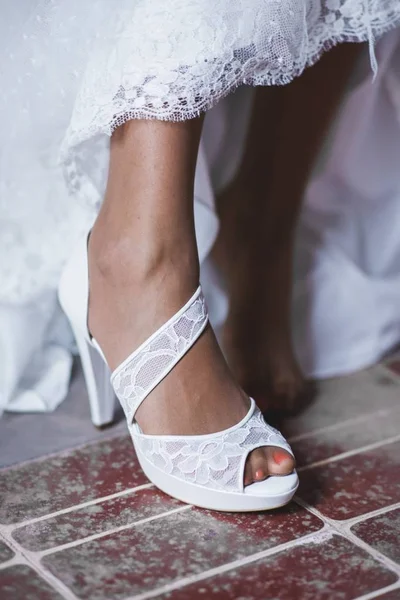 Bridal shoes on her wedding wearing on the feet of the bride