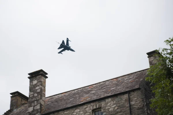 Plane f18 flying over a population.