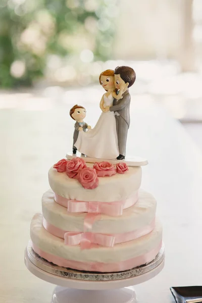 Desserts and wedding cake with very sweet cupcakes at an event.