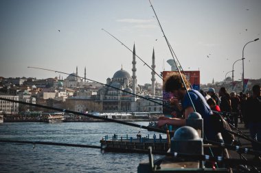 Istanbul, Türkiye - 5 Nisan 2012: onların çubuklar üzerinde Boğaz köprüleri ile Balık tutma Türk vatandaşları.