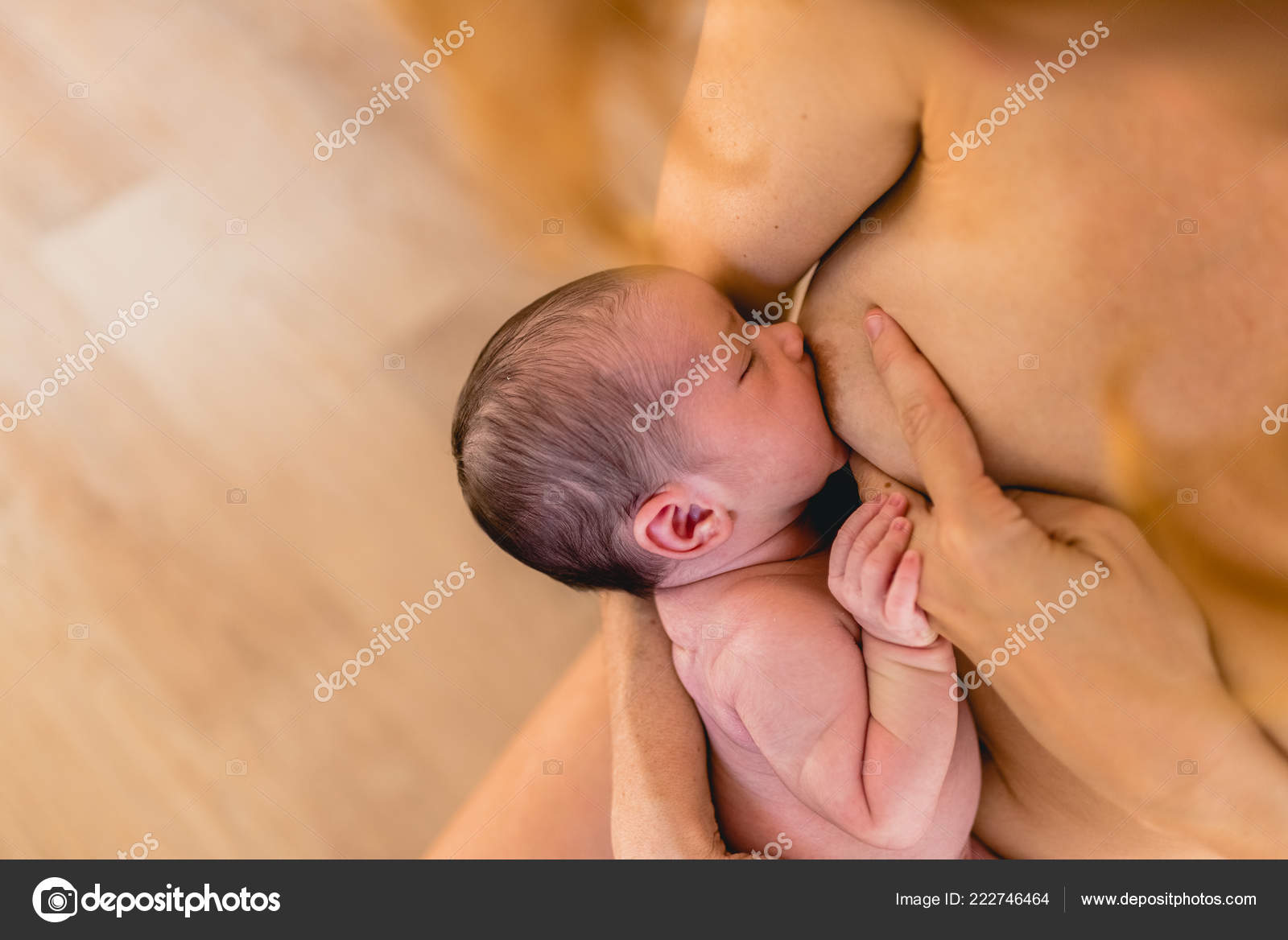Mother is breast-feeding a newborn baby. Little baby girl breast feeding  Stock Photo