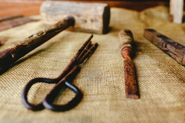 Old and rusty tools to work the wood in a boat.