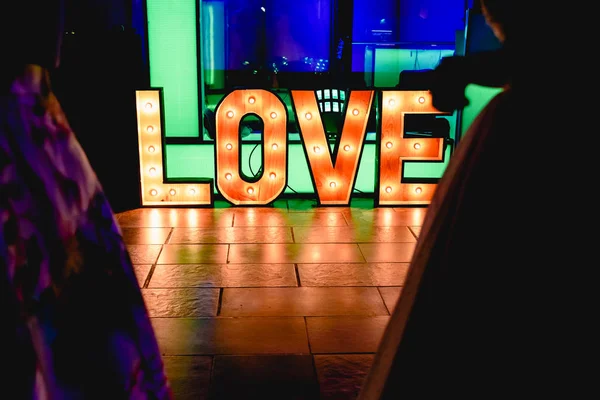 Bright wooden letters with word Love in a party
