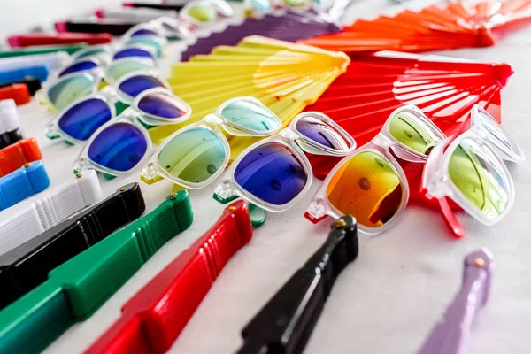 Fun set of fans and sunglasses of many colors for parties in summer.