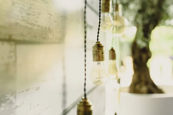 Elongated decoration bulbs hanging from the wooden ceiling.