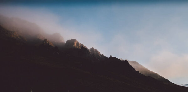 High Icelandic or Scottish mountain landscape with high peaks and dramatic colors