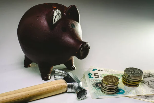 About to break piggy bank with English money to face savings in times of economic crisis.