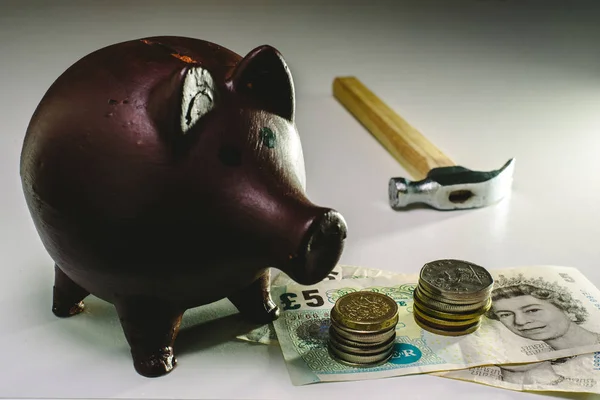 About to break piggy bank with English money to face savings in times of economic crisis.