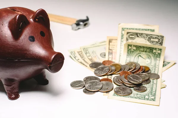 piggy bank to save with hammer, concept of personal finances in dollars