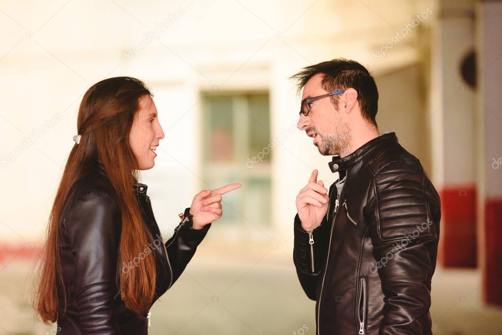 Angry millennial couple arguing and blaming each other of problem frustrated about their relationship