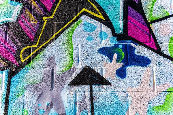 Background with wall texture painted colorful arrows and graffit — Stock Photo, Image