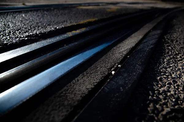 Tracks of an urban tram between the asphalt of a street. — Stock Photo, Image