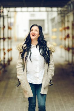 Orta yaşlı kadın gülümseyen ve mutlu bir şekilde yürürken gülüyor