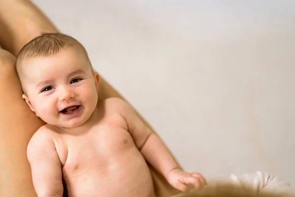 Newborn baby girl posed on her back, on white blanket, looking a — Stock Photo, Image