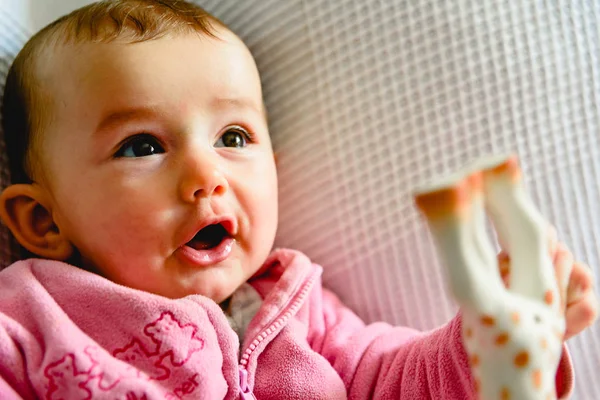 Adorable funny baby girl smiling with pink pajamas. — Stock Photo, Image