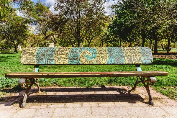 Wooden bench to rest decorated with a beautiful design of labyri — Stock Photo, Image