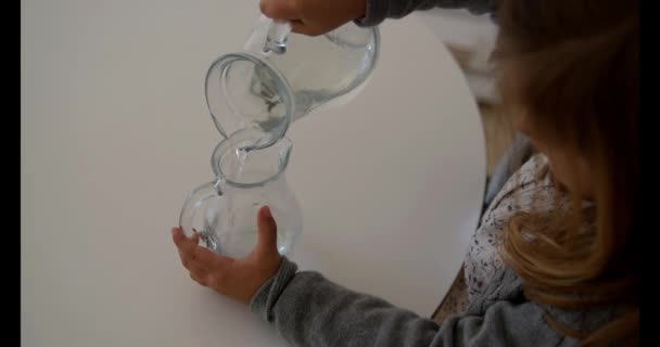 Student Girl Montessori Pedagogy Transferring Water Two Little Jars — Stock Video