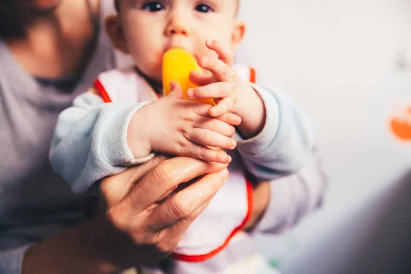 Baby savoring an orange ice cream. — Stock Photo, Image