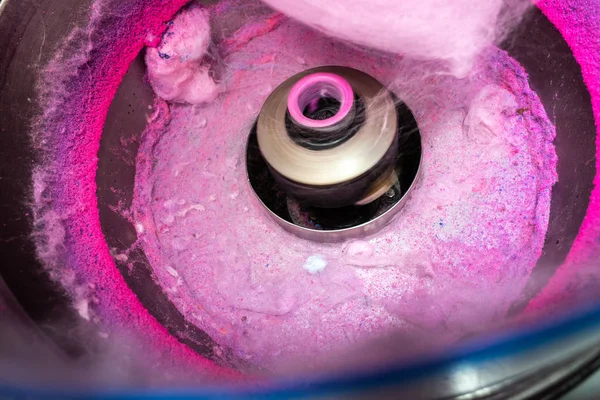 Machine to make cotton candy by turning and toasting the pink su