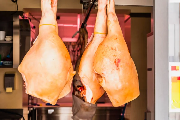 Matera, Italy - March 11, 2019: Pork hams hung in a dryer. — Stock Photo, Image