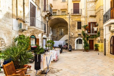 Colorful and old alleys of the touristic Italian city of Bari. clipart