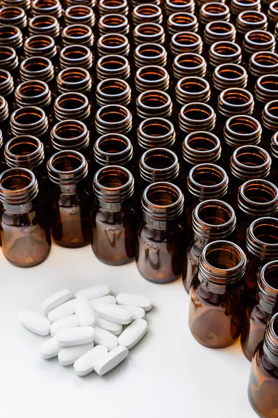 Heap of pills with empty medicine containers, pharmaceutical ind — Stock Photo, Image