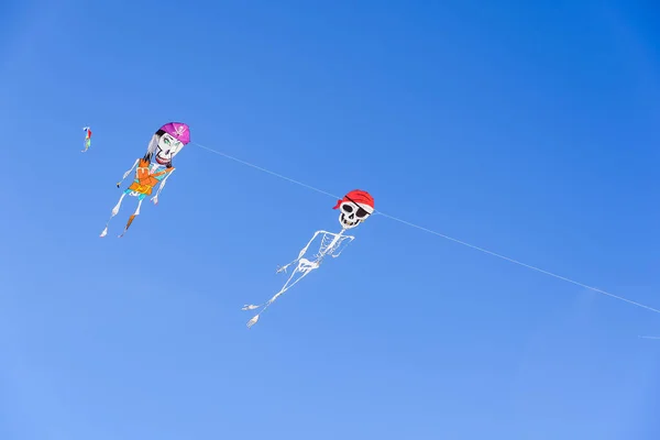 Two pirate skeleton-shaped kites, fun figures to play on hot sum