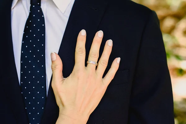 A woman in love leans with her hand on the chest of his man dres — Stock Photo, Image