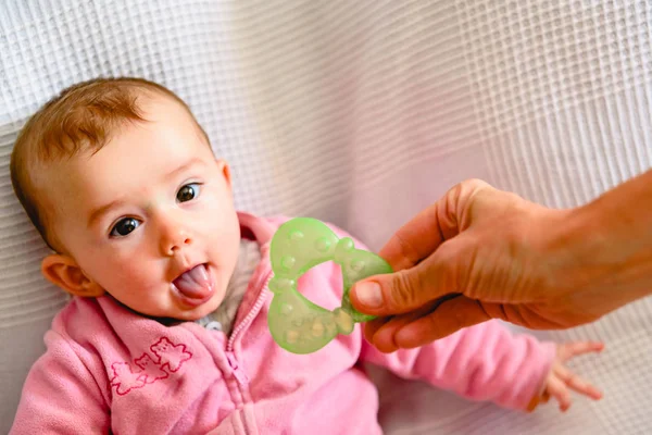 Beautiful and friendly 6 month old baby girl teething and biting — Stock Photo, Image
