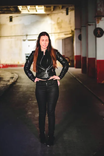 Portrait of young female model dressed in black leather posing c — Stock Photo, Image