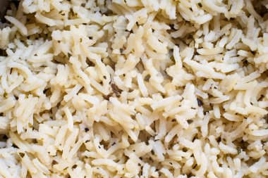 Baharatlarla pişirilen bir avuç basmati pirincinin yakın çekimi, backgr