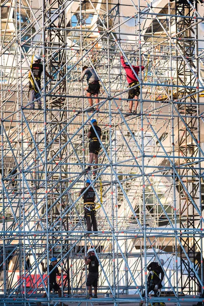 Valencia, Spain - May 28, 2019: Workers assembling a stage for a