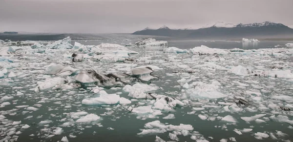 Huge blocks of ice on Glacial river and blue icebergs on Jokulsa