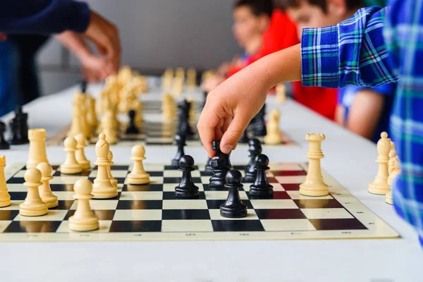 Barnets hand flyttar hästen under en schackturnering med Seve — Stockfoto