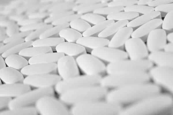 Macro close-up of many white pills, medication concept — Stock Photo, Image