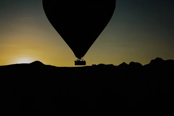 Silhouette von Reisenden und Touristen, die bei su über Berge fliegen — Stockfoto