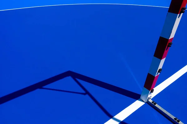 Palo blanco y rojo de un gol en un campo de fútbol y azul — Foto de Stock