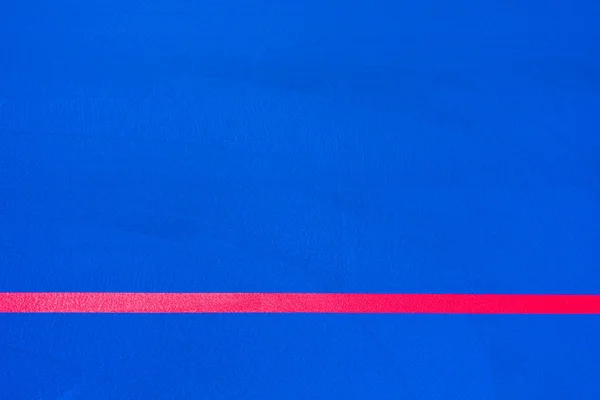 Red lines crossing a floor painted blue of intense color to use