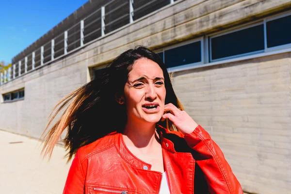 Scared woman is scared and makes a panic face while screaming fo