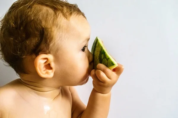 Baby in profile eating a watermelon drooling and getting dirty w — Stock Photo, Image