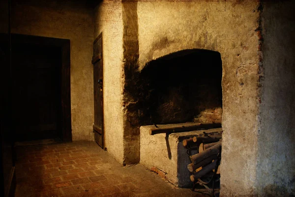 Interior of an old manor house with fireplace ready to light wit