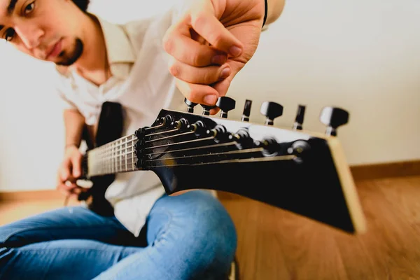 Chitarrista posa con la sua chitarra elettrica, sfondo bianco . — Foto Stock