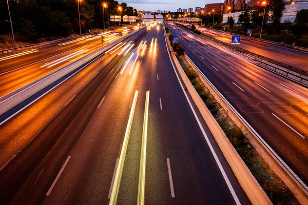 stock image Trails of car lights on a large road at night.