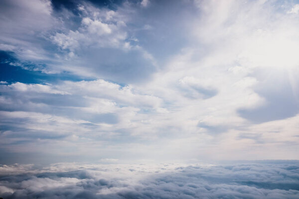 Scene of a winter cloudy sky from the top of a mountain peak.