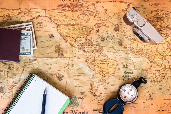 A traveler plans his trip around the world on an old map, while